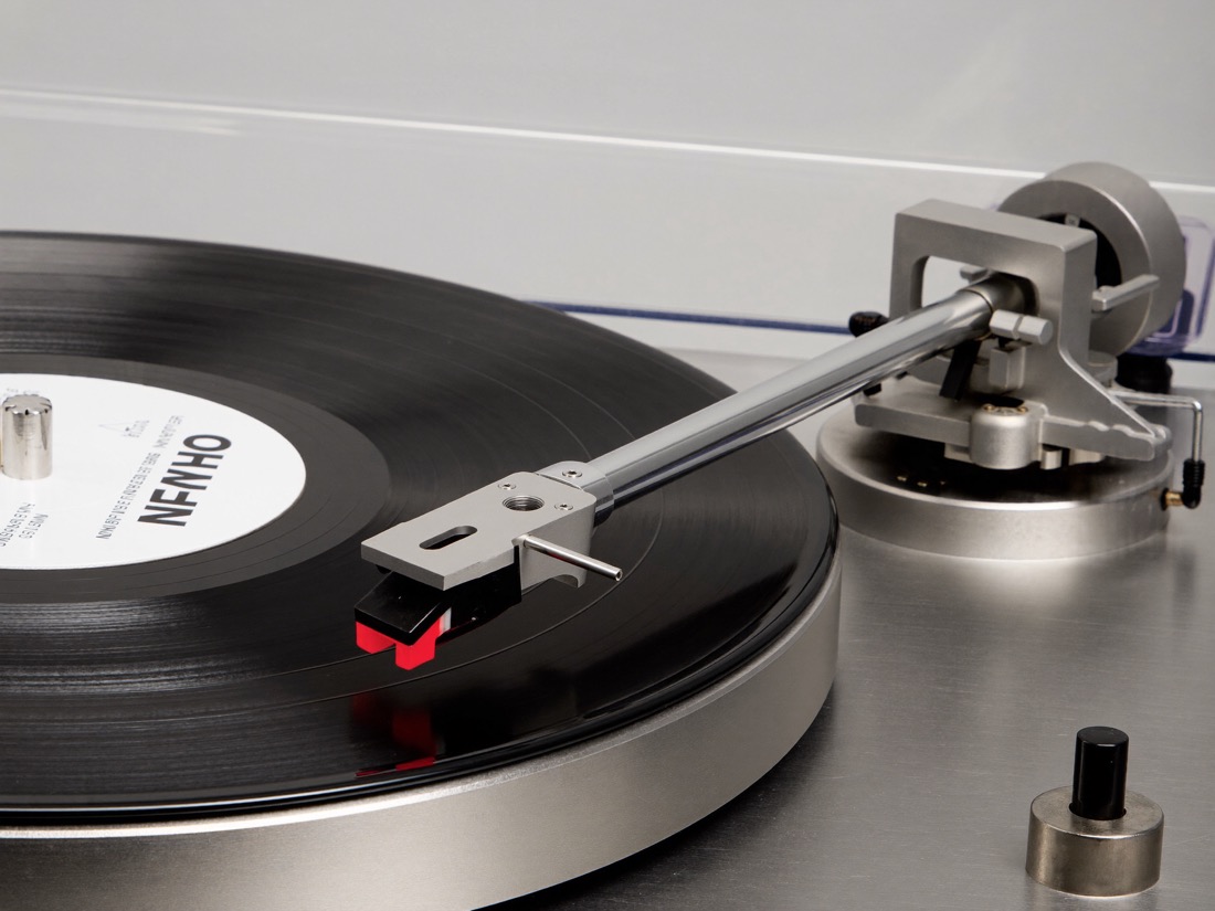 Testina e braccio di un giradischi in lettura su un disco